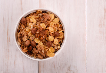 Top view of corn flakes and nuts in bowl
