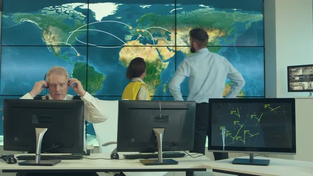  Time lapse security & surveillance team working in system control room. Could be a meteorological weather station or airport traffic control room. 