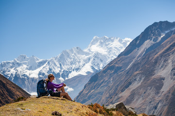 Naklejka na ściany i meble Trekker rests on Manaslu circuit trek in Nepal