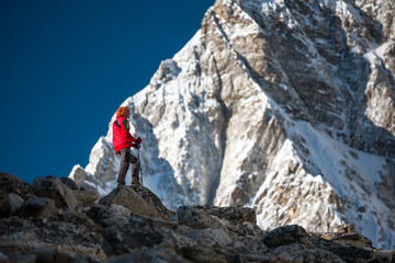 Trekker approaching PumoRi mountain in Khumbu valley on a way to Everest Base camp
