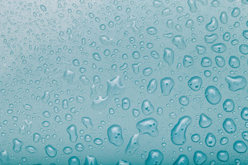Drops of water on a color background. Blue. Selective focus. Toned