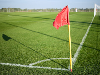 Red flag in corner of football playground,