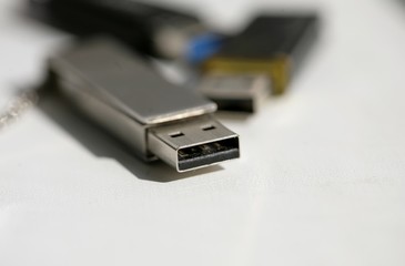 Close up of USB memory stick on white background; selective focus.