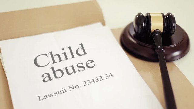 Child abuse lawsuit verdict with gavel placed on desk of judge in court