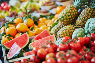 Fresh organic watermelons and pineapples on farmers market