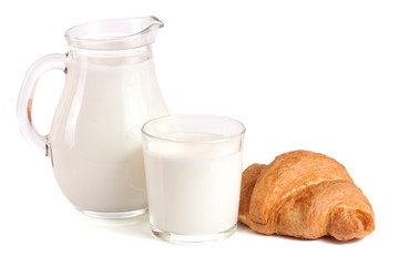 Jug and glass of milk with croissant isolated on white background