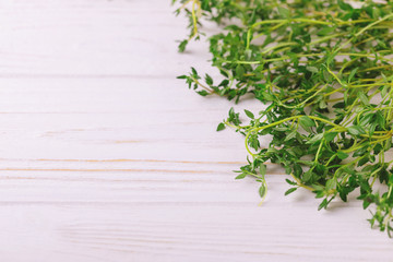 Bunch of fresh organic thyme on wooden background