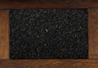 black cumin in wooden box isolated