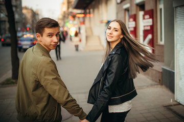 Obraz premium True love emotions of joyful cute couple enjoying time together outdoor in city. Lovely happy moments, having fun, smiling in love on the background of the city.