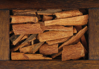 cinnamon (cassia) in wooden box isolated