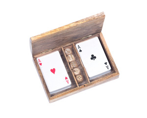 Playing poker cards and dice in wooden box isolated on white background