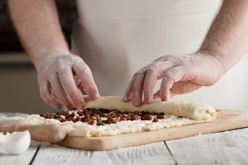 Close-up the hand of a baker kneading and shaping dough