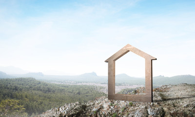 Conceptual image of concrete home sign on hill and natural landscape at background