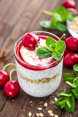 Fresh cherry yogurt with oats and chia seeds, delicious dessert for healthy breakfast
