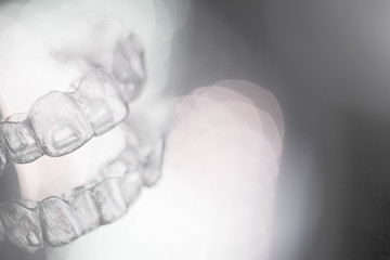 Invisible dental orthodontics on colored background © gemaibarra