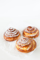 Sweet rolls with sugar and cinnamon on white background.