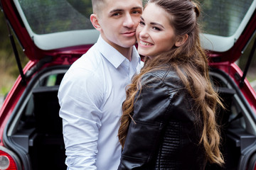 Beautiful guy with a girl smile, stand near the car, cool. Love story