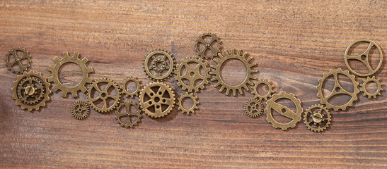 The gear on wooden background.