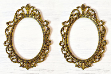 Two empty vintage picture frames on white grunge background