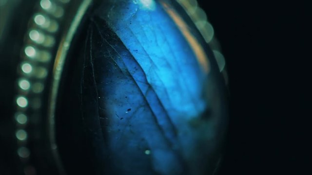 Ring with blue labradorite. Bright irisation. Macro view.