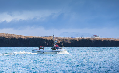 Fishing boat goes in bay of Reykjavik