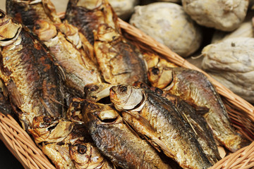 Dried, smoked, small fish used in Asian cuisine. Cooked sprat fish background or pattern. Delicatessen dried, smoked, sprat fish for beer on street food festival.