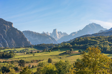 The foothills of the National Park Los Picos de Europa. In the background, peaks of the famous mountain Naranjo de Bulnes