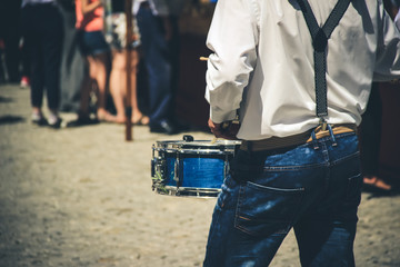 Man playing the drum with a street music group