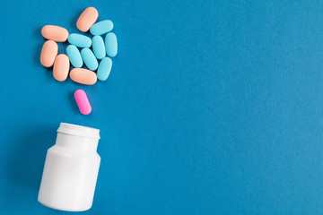 Cure for all diseases on a blue background. A bottle of pills