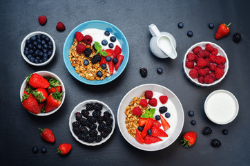 Healthy breakfast with granola, greek yogurt, berries and milk