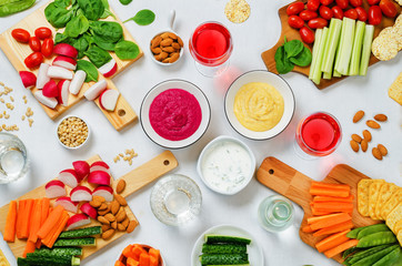Obraz na płótnie Canvas Variation of healthy vegan snacks. Vegetables, crackers, dip and hummus