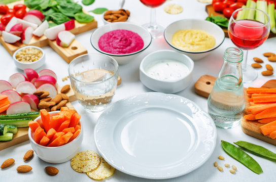 Variation of healthy vegan snacks. Vegetables, crackers, dip and hummus