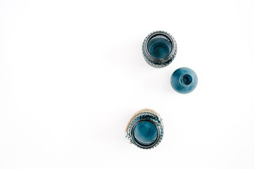 Three blue stylish jars on white background. Top view minimal decoration concept.