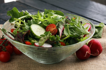 Bowl of salad on wooden table