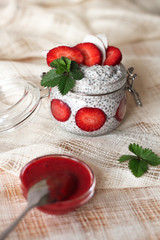 Chia pudding with strawberries in small bowls on a linen tablecloth