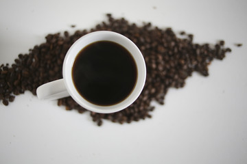 Obraz na płótnie Canvas White Mug of Coffee in a Pile of Coffee Beans