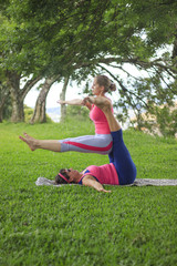 Women performing Yoga and acrobatic movements aminst nature.