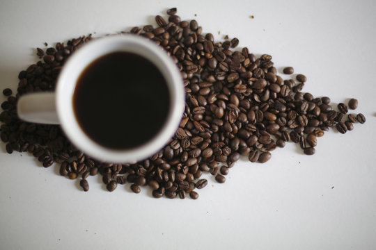 White Coffee Mug in Coffee Beans