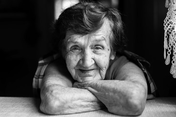 Portrait close-up of a happy elderly woman. Black and white photo.