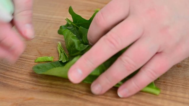 Spinach leaves on a board.
