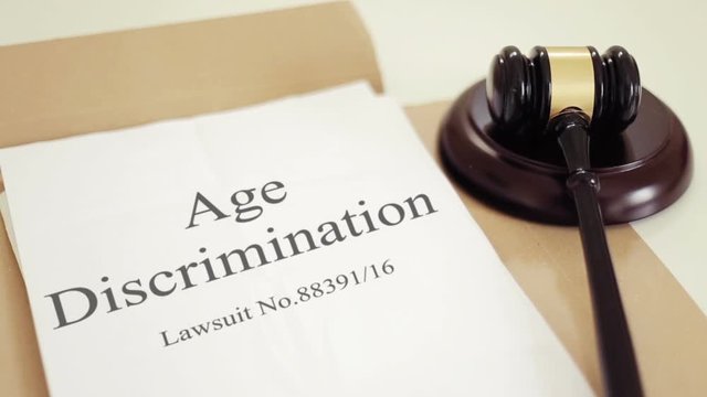 Age Discrimination verdict folder with gavel placed on desk of judge in court