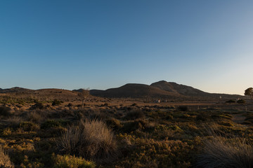 Fototapeta premium sunset over a dried plain an mountains