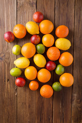Orange and lemon, lime, sicilian orange on a wooden background. Citrus fruits. Mixed festive colorful tropical and citrus fruit. Healthy eating photo concept. Copyspace