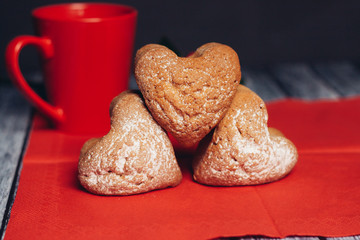 Red mug and muffins on the table
