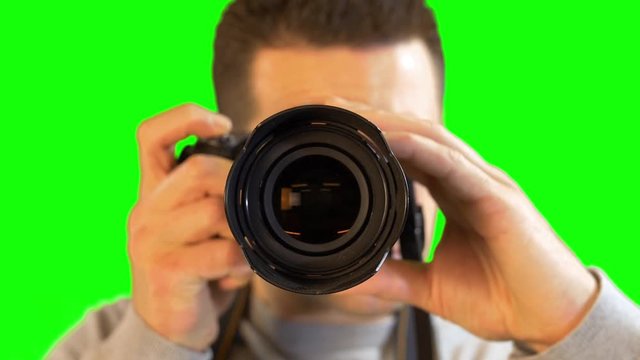 Greenscreen Photographer Close Up Facing Straight Zooming Lens of DSLR Camera