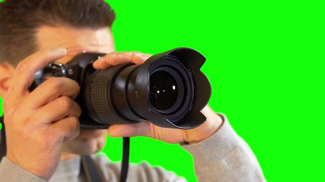 Greenscreen Photographer Close Up Holding DSLR Camera with Big Lens Snapping Picture