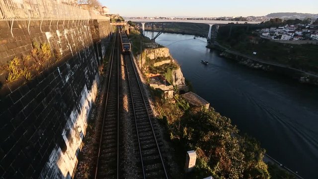Subway train passing in a tunnel on the bank of the Dora river in Porto, Portugal.