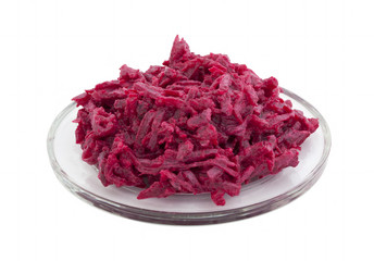 Salad of beetroot with garlic and mayonnaise on a transparent plate on a white background. Isolated