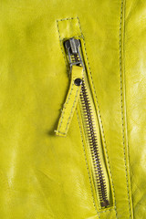 Green leather jacket zippers. Leather jacket macro details. Jacket zippers and pockets