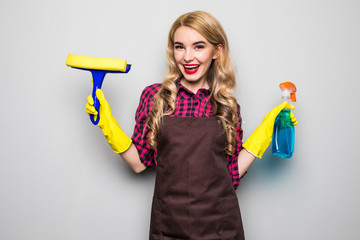 Smiling woman holding bottle of chemistry for cleaning house.